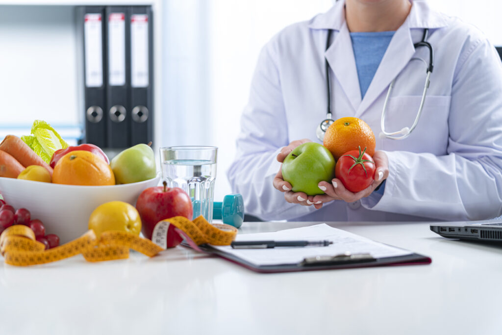 Nutritionist holding some fruits and vegetables