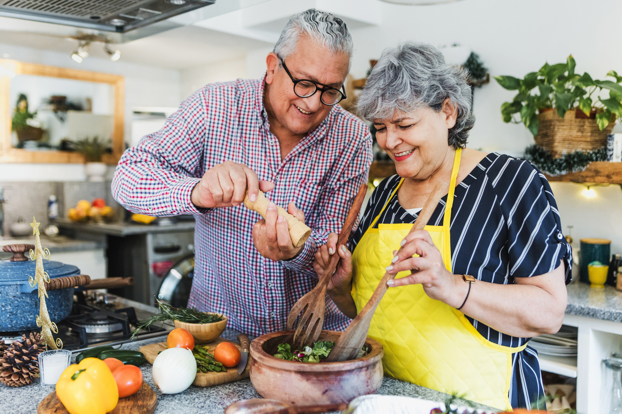 Latin senior couple cooking dinner at home in Mexico Latin America, hispanic elderly people preparing food